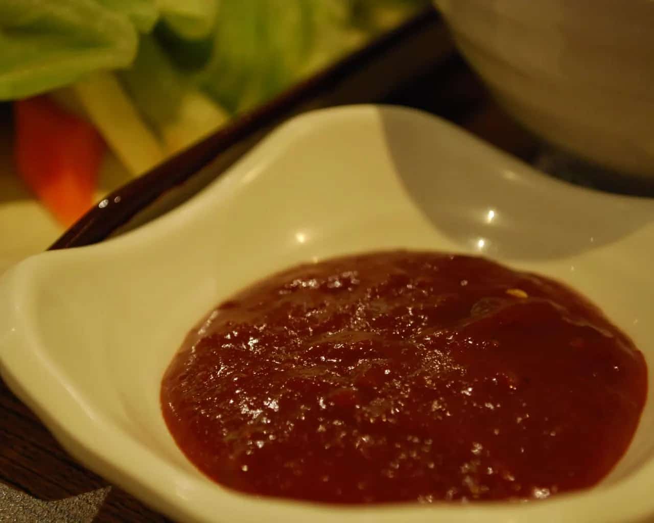 Deep red Korean gochujang served in a small dish