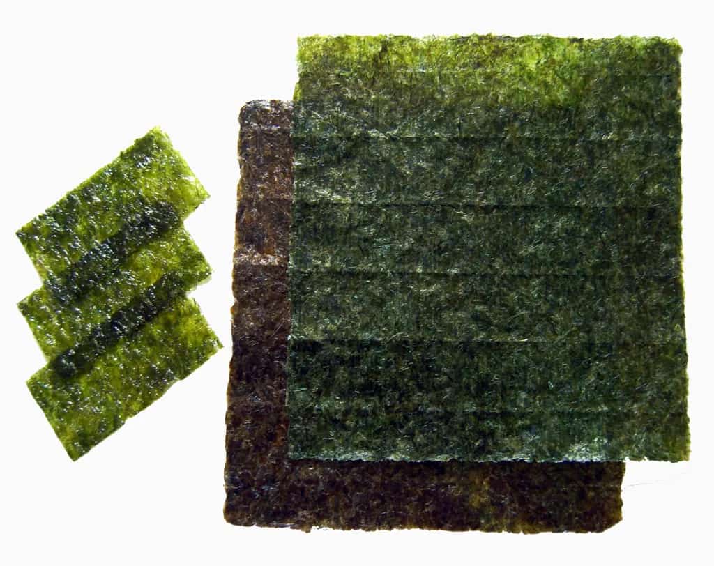Full roasted nori sheets beside smaller seasoned seaweed sheets