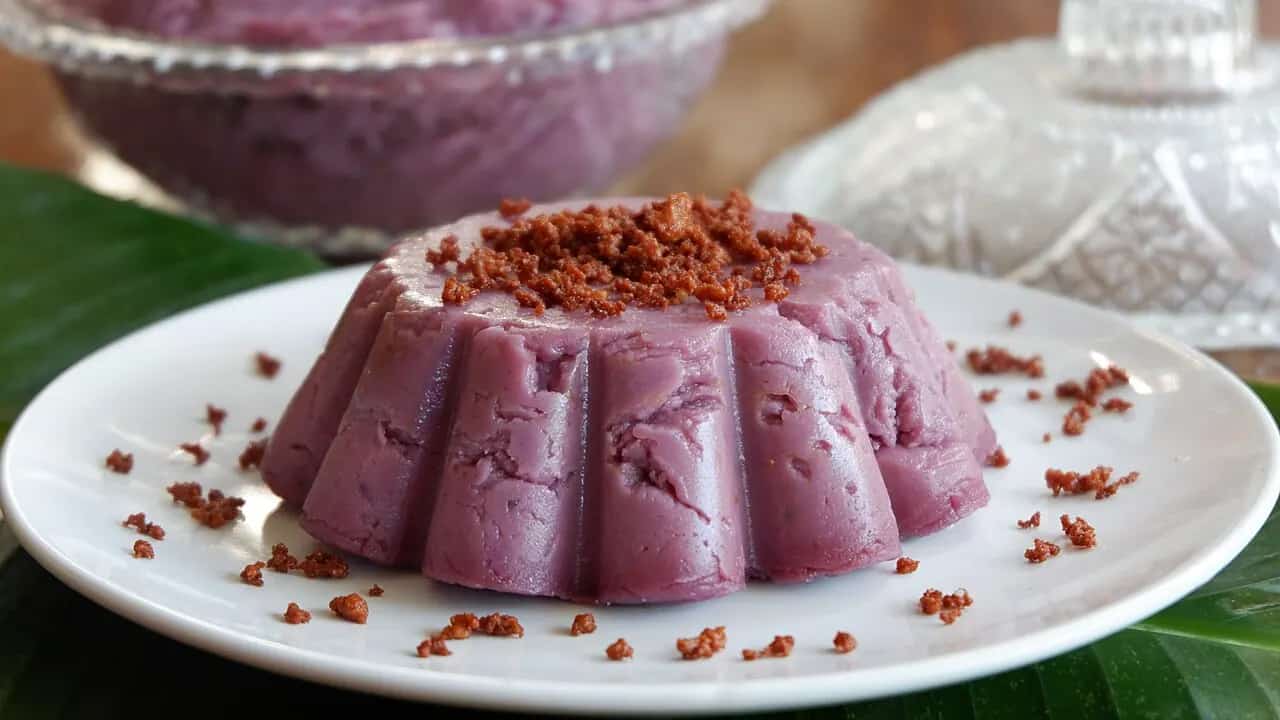 Purple ube halaya Filipino dessert topped with toasted coconut curds